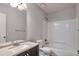 Bathroom featuring a dark vanity, granite counter, tiled shower over tub and modern fixtures at 5577 Whittondale Rd, Lithonia, GA 30058