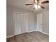 Bedroom with ceiling fan, closet with folding doors and wood look flooring at 5577 Whittondale Rd, Lithonia, GA 30058
