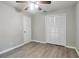 This bedroom features a ceiling fan, a closet, and light hardwood flooring at 5577 Whittondale Rd, Lithonia, GA 30058