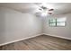 Clean and bright bedroom featuring wood-look floors, neutral paint, and a ceiling fan at 5577 Whittondale Rd, Lithonia, GA 30058