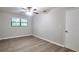 Bedroom featuring a ceiling fan, natural light from a large window and wood look flooring at 5577 Whittondale Rd, Lithonia, GA 30058