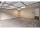 This garage features a cement floor, white walls and a white ceiling at 5577 Whittondale Rd, Lithonia, GA 30058