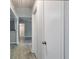 Bright hallway with wood look flooring and neutral walls leading to various rooms in the home at 5577 Whittondale Rd, Lithonia, GA 30058