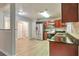 Bright kitchen showcasing stainless steel appliances and rich wood cabinetry at 5577 Whittondale Rd, Lithonia, GA 30058