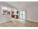 Spacious living room featuring wood-look flooring and an open view into the kitchen area at 5577 Whittondale Rd, Lithonia, GA 30058