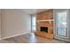 Open living room featuring wood-look flooring and fireplace with tiled hearth at 5577 Whittondale Rd, Lithonia, GA 30058