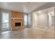 Inviting living room with wood-look flooring, natural light, and a tiled fireplace at 5577 Whittondale Rd, Lithonia, GA 30058