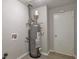 Image shows water heater in a utility room of the house with light gray walls at 5577 Whittondale Rd, Lithonia, GA 30058