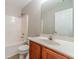 Bathroom featuring a vanity with sink, mirror, toilet and a shower-tub, offering a functional layout at 1346 Upshur Pl, Buford, GA 30519