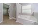 Bathroom features large soaking tub and a separate shower with glass door at 1346 Upshur Pl, Buford, GA 30519