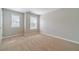 A bright bedroom with a view outside from the large windows, offering lots of natural light, and carpet floors at 1346 Upshur Pl, Buford, GA 30519
