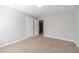 Bedroom featuring soft walls and carpet floor, with a white door that leads to more living space at 1346 Upshur Pl, Buford, GA 30519