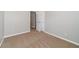 Bedroom with neutral walls, carpet flooring, and white doors, creating a serene and inviting atmosphere at 1346 Upshur Pl, Buford, GA 30519