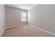 This cozy bedroom offers neutral walls, carpet flooring and window that allow natural light into the space at 1346 Upshur Pl, Buford, GA 30519