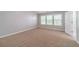Bedroom boasts neutral carpeting, large windows, and plenty of natural light at 1346 Upshur Pl, Buford, GA 30519