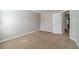 Bedroom featuring soft, neutral carpet and walls, plus a white door leading to more living space at 1346 Upshur Pl, Buford, GA 30519