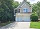 Charming home with a two-car garage and a well-manicured lawn at 1346 Upshur Pl, Buford, GA 30519
