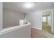 Upstairs hallway features carpeted floors and a railing overlooking the stairs at 1346 Upshur Pl, Buford, GA 30519
