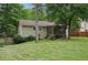Enjoy this home's large, green backyard with mature trees and a screened-in patio, perfect for outdoor living at 1952 Winding Creek Sw Ln, Marietta, GA 30064