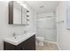 This cozy bathroom has a double sink vanity, a shower with sliding doors, and integrated shelving for storage at 1952 Winding Creek Sw Ln, Marietta, GA 30064