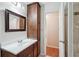 Bathroom features a dark wood vanity, mirror, and tiled shower at 1952 Winding Creek Sw Ln, Marietta, GA 30064