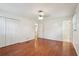 Bedroom with hardwood floors features an ensuite bathroom, double-door closet, and neutral walls at 1952 Winding Creek Sw Ln, Marietta, GA 30064