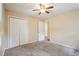 This neutral bedroom features a ceiling fan, plush carpeting, and a double-door closet for ample storage at 1952 Winding Creek Sw Ln, Marietta, GA 30064