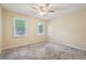 Bedroom featuring neutral carpet, a ceiling fan, and two windows for natural light at 1952 Winding Creek Sw Ln, Marietta, GA 30064