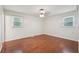 Bright bedroom featuring hardwood floors, two windows, and neutral-colored walls for a minimalist aesthetic at 1952 Winding Creek Sw Ln, Marietta, GA 30064