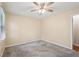 Bedroom featuring neutral carpet, a ceiling fan, and a window for natural light at 1952 Winding Creek Sw Ln, Marietta, GA 30064