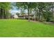 Beautiful property with a sprawling green lawn, mature trees, and a well-maintained exterior at 1952 Winding Creek Sw Ln, Marietta, GA 30064
