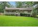 Charming one-story home featuring a covered front porch, light green siding, and a well-manicured lawn at 1952 Winding Creek Sw Ln, Marietta, GA 30064