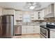 Bright kitchen features stainless steel appliances, ample cabinetry, and stone backsplash detail at 1952 Winding Creek Sw Ln, Marietta, GA 30064