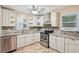 Well-appointed kitchen with white cabinets, granite countertops, stainless steel appliances, and tile backsplash at 1952 Winding Creek Sw Ln, Marietta, GA 30064