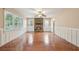 Spacious living room featuring hardwood floors, a stone fireplace, and ample natural light at 1952 Winding Creek Sw Ln, Marietta, GA 30064