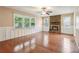 Spacious living room featuring hardwood floors, a stone fireplace, and large windows at 1952 Winding Creek Sw Ln, Marietta, GA 30064