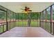 This spacious screened-in patio features a ceiling fan, beautiful woodwork, and views of the backyard at 1952 Winding Creek Sw Ln, Marietta, GA 30064