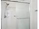 This bright shower stall with sliding glass doors features an adjustable shower head and integrated shelves at 1952 Winding Creek Sw Ln, Marietta, GA 30064