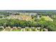 Aerial view of homes in a neighborhood near a pond surrounded by lush greenery, offering a serene setting at 2851 Weatherstone Se Cir, Conyers, GA 30094