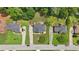Aerial view of three well-maintained homes with long driveways, lush landscaping and mature trees at 2851 Weatherstone Se Cir, Conyers, GA 30094