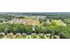 Aerial view of homes in a neighborhood near a pond surrounded by greenery at 2851 Weatherstone Se Cir, Conyers, GA 30094