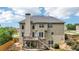 Two-story house with a deck, staircase, and a well-maintained backyard and lush green trees at 2851 Weatherstone Se Cir, Conyers, GA 30094