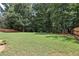 Expansive backyard with lush green grass and mature trees, perfect for outdoor activities and relaxation at 2851 Weatherstone Se Cir, Conyers, GA 30094