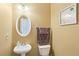 Well-lit half bathroom featuring a pedestal sink, an oval mirror, and neutral wall color at 2851 Weatherstone Se Cir, Conyers, GA 30094