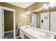 This bathroom features a large mirror over a double vanity with tile flooring at 2851 Weatherstone Se Cir, Conyers, GA 30094