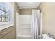 Bright bathroom with a shower, window, neutral colors, and great natural lighting at 2851 Weatherstone Se Cir, Conyers, GA 30094