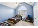 Bedroom with a vaulted ceiling, large window, and playful sports decor at 2851 Weatherstone Se Cir, Conyers, GA 30094