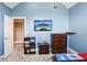 This bedroom features blue walls, a mounted TV, carpeted floors and a ceiling fan at 2851 Weatherstone Se Cir, Conyers, GA 30094