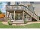 View of the wooden back deck, featuring stairs leading to the upper level and a cozy seating area below at 2851 Weatherstone Se Cir, Conyers, GA 30094