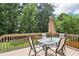 Outdoor wooden deck with table, umbrella and chairs provides the perfect space for entertaining and relaxation at 2851 Weatherstone Se Cir, Conyers, GA 30094